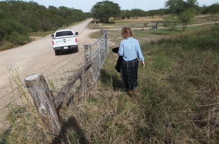Marianna Wright walks at the center near a Border Patrol truck.