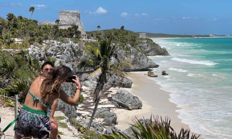 Tourists enjoy the pre-Columbian Mayan site of Tulum on the eastern coast of the Yucatán Peninsula.
