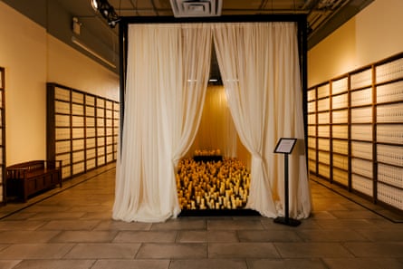 A curtained-off section of a room filled with candles.