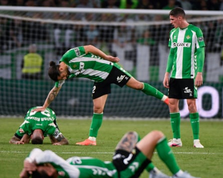 Real Betis players are crestfallen after Sevilla fought back from 2-0 down to draw 2-2 in the derby
