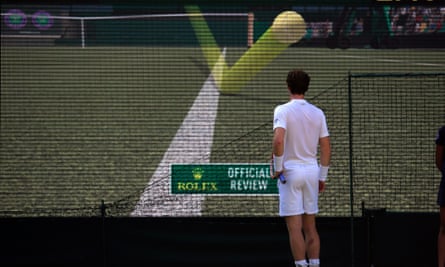Andy Murray watches a Hawk-Eye decision on the big screen during his match against Ivo Karlovic at Wimbledon in 2015