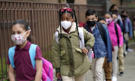FILE - Students line up to enter Christa McAuliffe School in Jersey City, N.J., Thursday, April 29, 2021. Gov. Phil Murphy is set to announce Friday, Aug. 6 that New Jersey students from kindergarten to 12th grade and staff members will be required to wear masks in schools when the new year begins in a few weeks, as COVID-19 cases rise in the state.  (AP Photo/Seth Wenig, File)