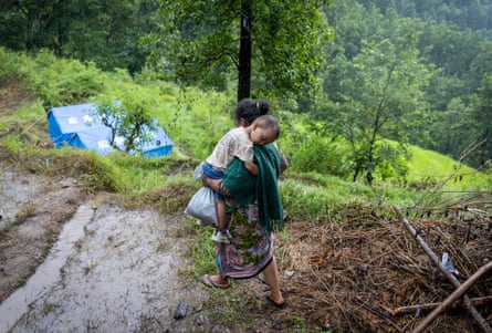 A woman and child displaced by deadly flash floods and mudslides on a hill in Nuwakot district, Nepal.