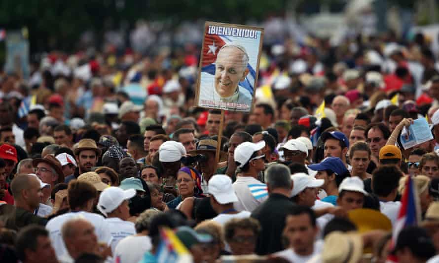A man holds a placard bearing a picture of Pope Francis as the pope performs mass on Sunday.