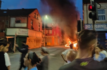 People standing close to the flames