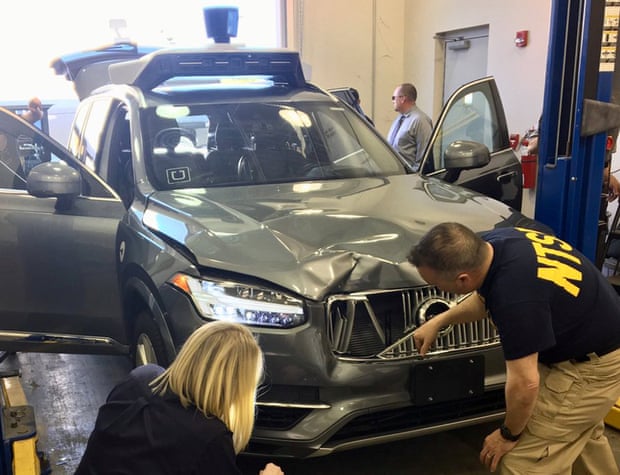 Investigators examine the vehicle involved in the fatal accident in Tempe, Arizona.