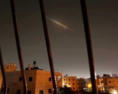 Missiles launched from Iran towards Israel seen over Hebron in the occupied West Bank on Saturday