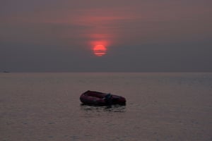 Dover, England An empty migrant dinghy floats off the beach at St Margaret’s Bay after the occupants landed from France