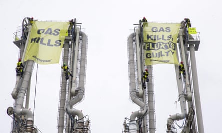 Greenpeace activists climb atop a gas pipeline structure at the Fluxys liquid gas (LNG) terminal.