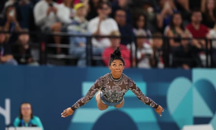 Simone Biles takes to the air in her floor routein at Bercy Arena.