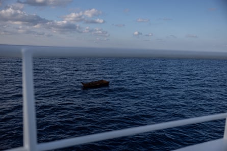 An empty boat drifts in the Mediterranean.