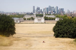 A man sits in a dry Greenwich Park in London