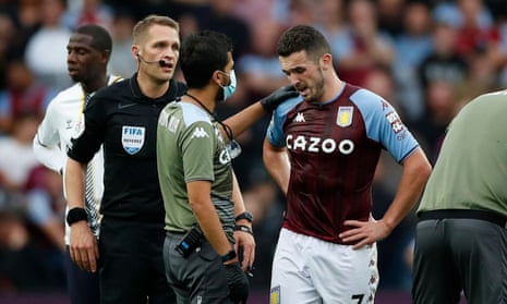 Aston Villa's John McGinn receives medical attention before being replaced by a concussion substitute in the Premier League this season.
