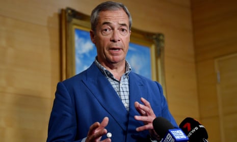 Nigel Farage gestures as speaks in front of microphones at a press briefing