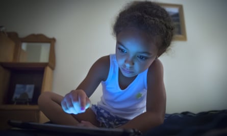Young child looking at a screen