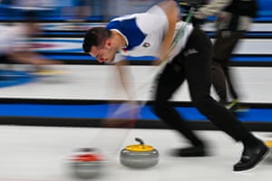 Winter Olympics day six: Johaug wins second gold, ice hockey and more – live! - The Guardian 5 Italy’s Sebastiano Arman sweeping hard.