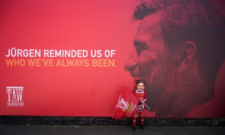 Liverpool Football Club fans stop to take photographs beside a new mural of manager Jurgen Klopp outside Anfield Stadium