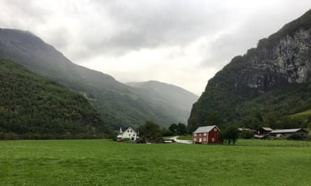 Houses at the base of two sloping mountainsides