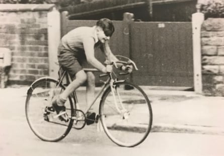 Paul Smith, aged 11, in shorts and jumper is peddling a racing bike in a black and white photograph.