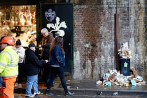 Borough Market scene with people and rubbish against a wall