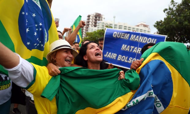 Supporters react near the house of Jair Bolsonaro, far-right lawmaker and presidential candidate during the presidential election, in Rio de Janeiro on Sunday.