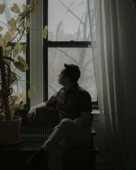 A man sits and looks out the window