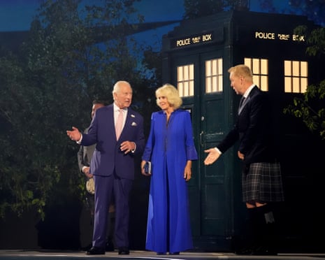 King Charles and Queen Camilla are greeted by Sir Chris Hoy after stepping out of the Tardis
