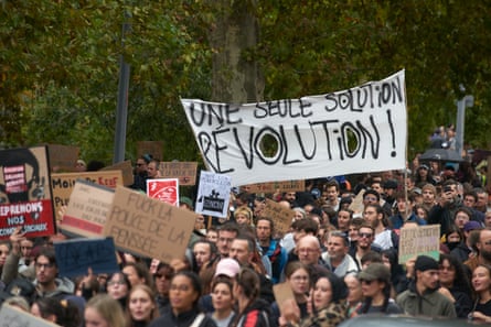 Protesters in Toulouse hold signs and a banner reading âÂÂOnly one solution: revolution.âÂÂ