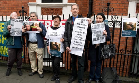 Peter Tatchell (second from right) holds a message of support for WikiLeaks outside the Ecuadorian embassy in London.