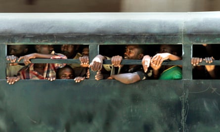 Unidentified prisoners are transported in the back of a truck through central Khartoum in Sudan.