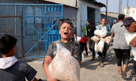 People carry food from aid centre