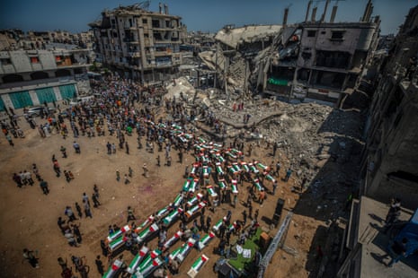 Palestinians gather during a mass funeral for 112 members of the Abu Sharia and Al-Hasayna families in the eastern Gaza City, 04 August 2026.