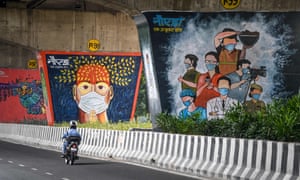Coronavirus-themed murals in Noida, a city in India, which reported 94,372 new cases on Sunday.