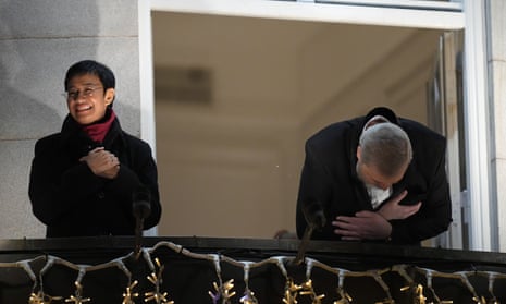 Nobel Peace Prize winners Dmitry Muratov from Russia, right, and Maria Ressa of the Philippines acknowledge the crowd gathered below as they stand on the balcony of the Grand Hotel in Oslo, Norway, Friday, Dec. 10, 2021. (AP Photo/Alexander Zemlianichenko, FIle)