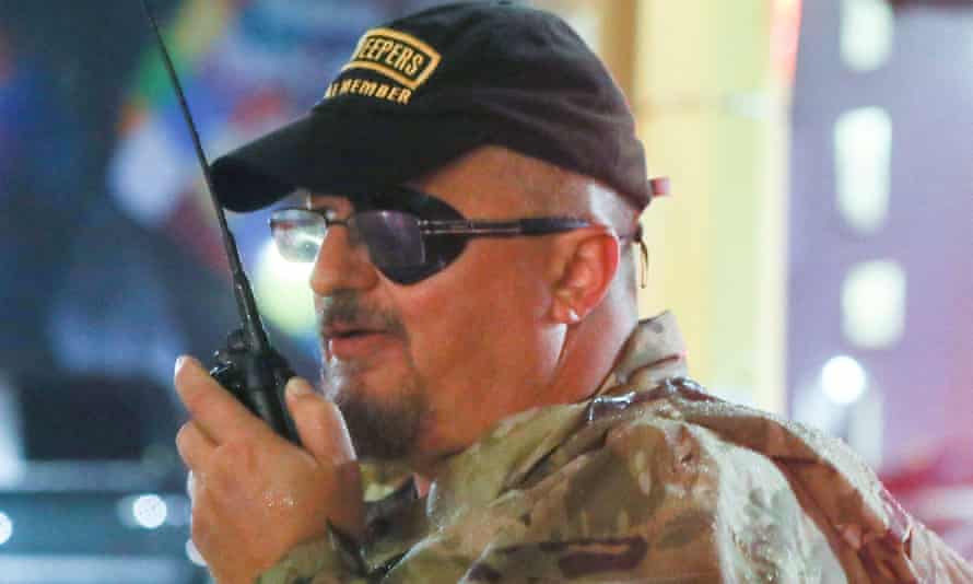 Far-right Oath Keepers leader to stay in jail until Capitol attack trial, judge rules | US Capitol attack 1 rhodes wears black hat and carries walkie talkie