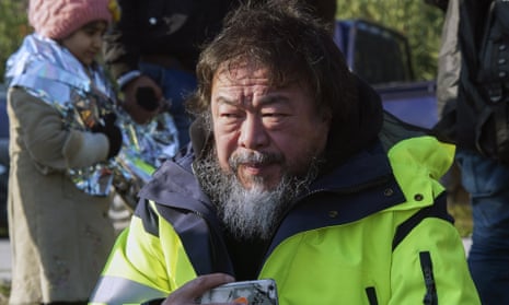 Ai Weiwei assists asylum seekers after their arrival by a dinghy from Turkey to the Greek island of Lesbos on 28 January.