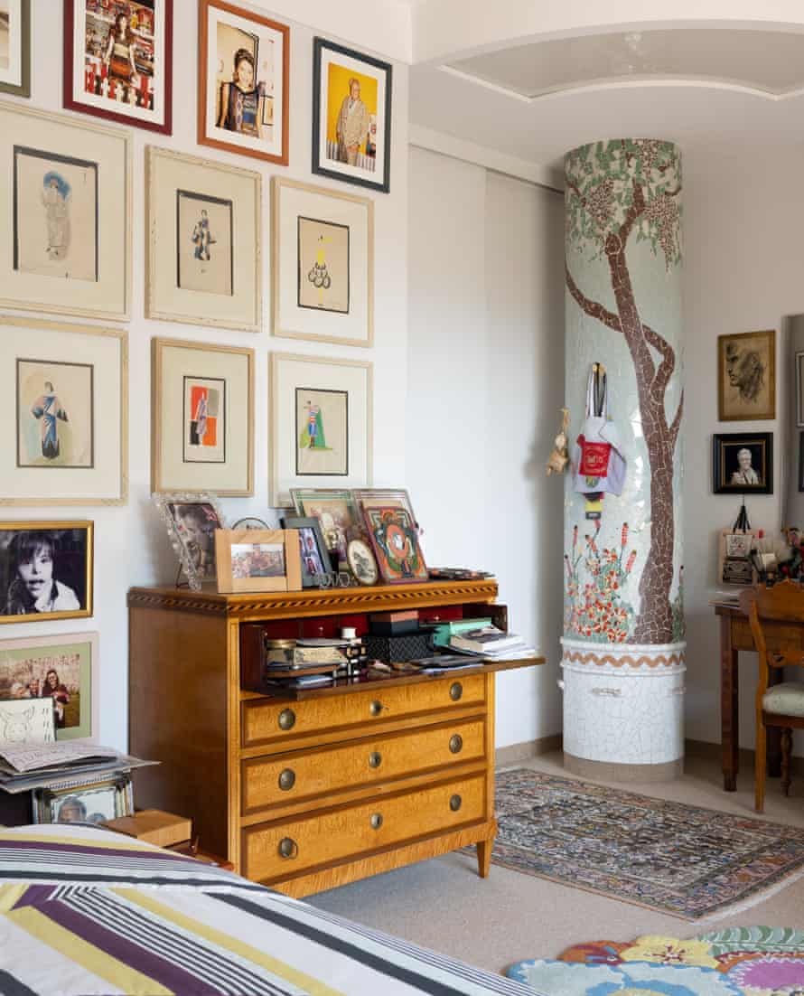 White walls set off artworks and curios in the hall.