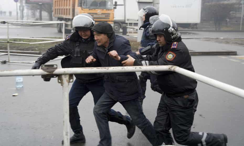 Police officers in Kazakhstan detain a demonstrator.