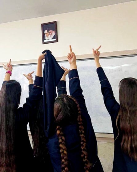 An image from social media showing Iranian schoolgirls showing what they think of the country's leadership.