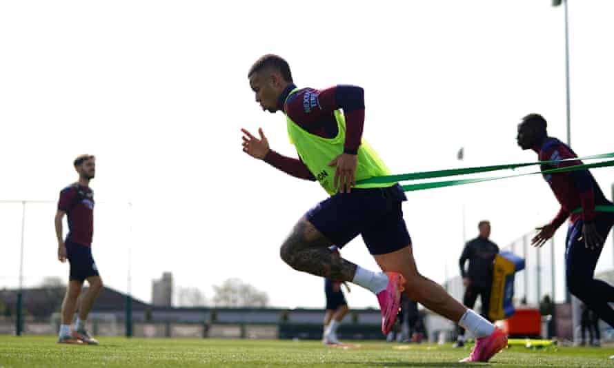 Manchester City striker Gabriel Jesus runs while wearing a resistance band during a training session.