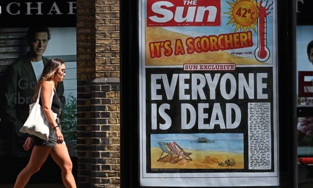 A pedestrian walks past a newspaper headline in London, 20 July 2022.