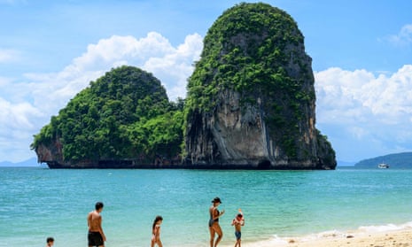 Tourists stroll Phra Nang Beach in Krabi on 30 October, 2021, as the country prepares to welcome visitors fully vaccinated against Covid-19 without quarantine from 1 November. 