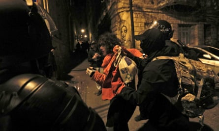 Police detain a protester.