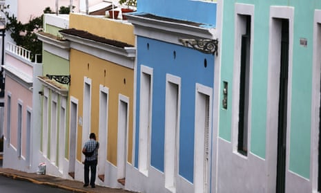A pedestrian walks through a street in Old San Juan as Puerto Rico’s economy continues to go downhill.