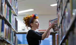 Female student looking at books in library