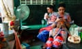 Thai dancers keep cool with cold drinks and a fan during the heatwaves in Thailand, where 30 people have died from heatstroke this year.