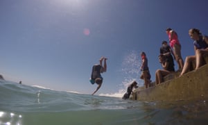 kids diving into beach-side pool