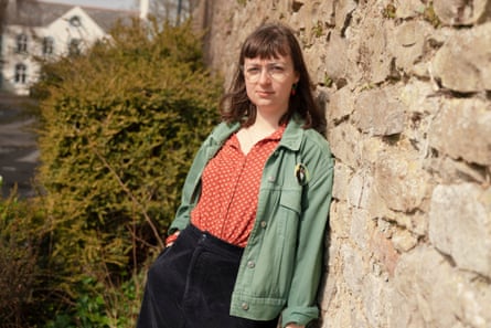 a woman poses for a portrait outside