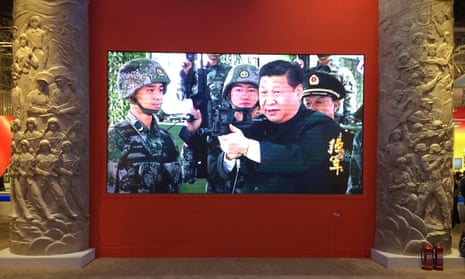 An exhibition in Beijing celebrating Xi’s first term show him brandishing a rifle, caressing a baby elephant and rubbing shoulders with British royalty.