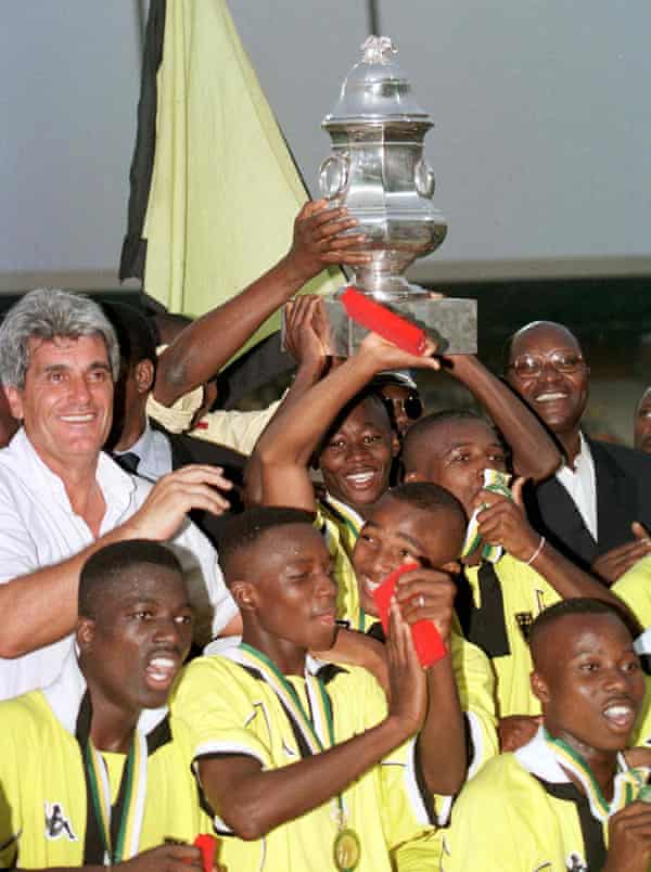 ASEC Mimosas coach Jean-Marc Guillou (left) celebrates with Ivory Coast prime minister Daniel Kablan Duncan (right) and his players after their victory over ES Tunis in the African Supercup in February 1999.